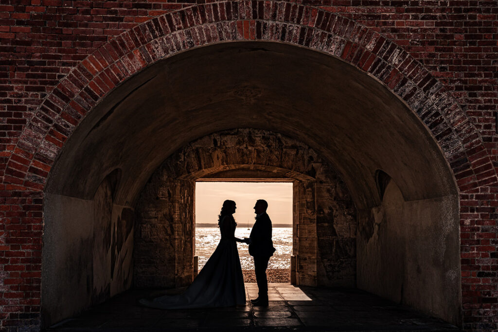 Bride and groom silhouetted in the brick tunnel at the Hot Walls, Old Portsmouth