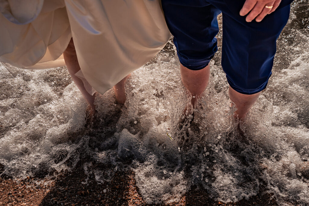 Bride and groom's feet in the waves at the Hot Walls, Old Portsmouth