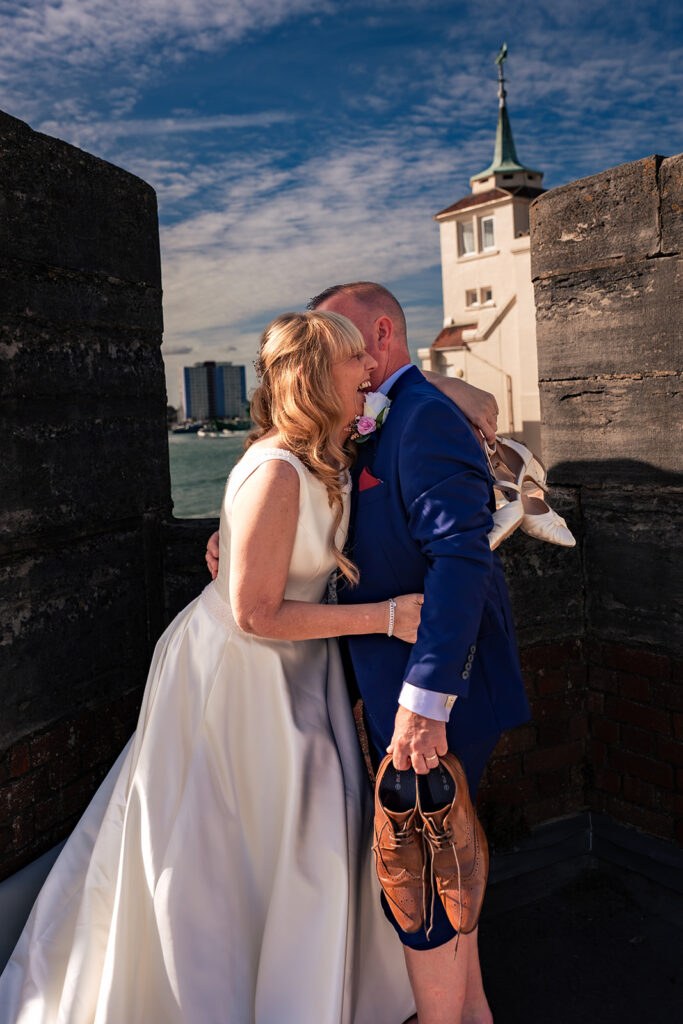 Bride and groom kissing by the Round Tower at the Hot Walls, Old Portsmouth