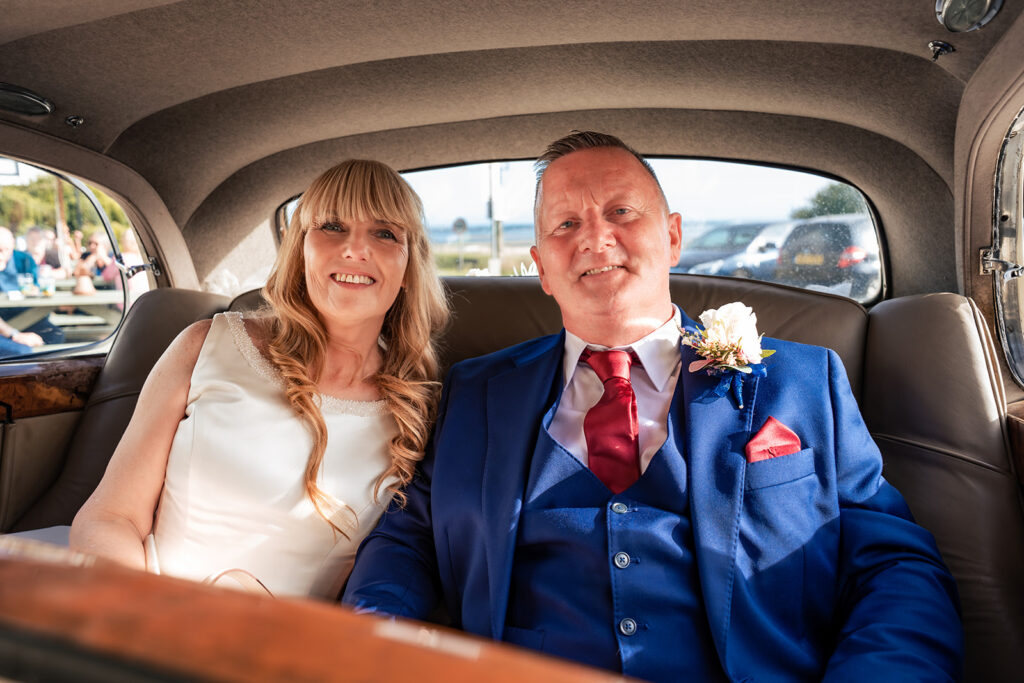 Bride and groom in the back of the vintage wedding car, Portsmouth