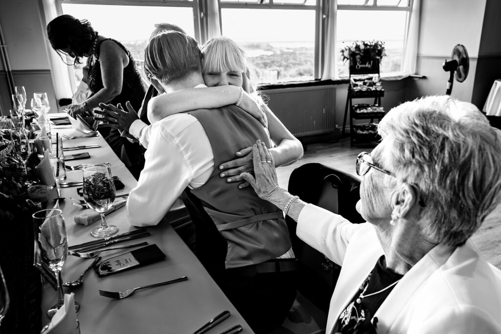 Guests laughing at the reception, black and white, at The Churchillian, Portsdown Hill, Portsmouth