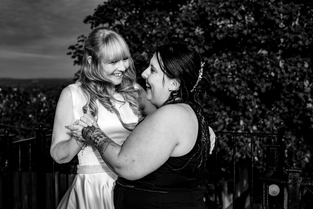 Bride hugging a guest, black and white, at The Churchillian, Portsdown Hill, Portsmouth