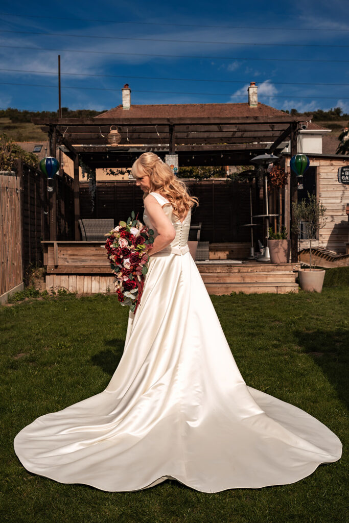 Bride in her wedding dress in the garden on the morning of a Portsmouth wedding