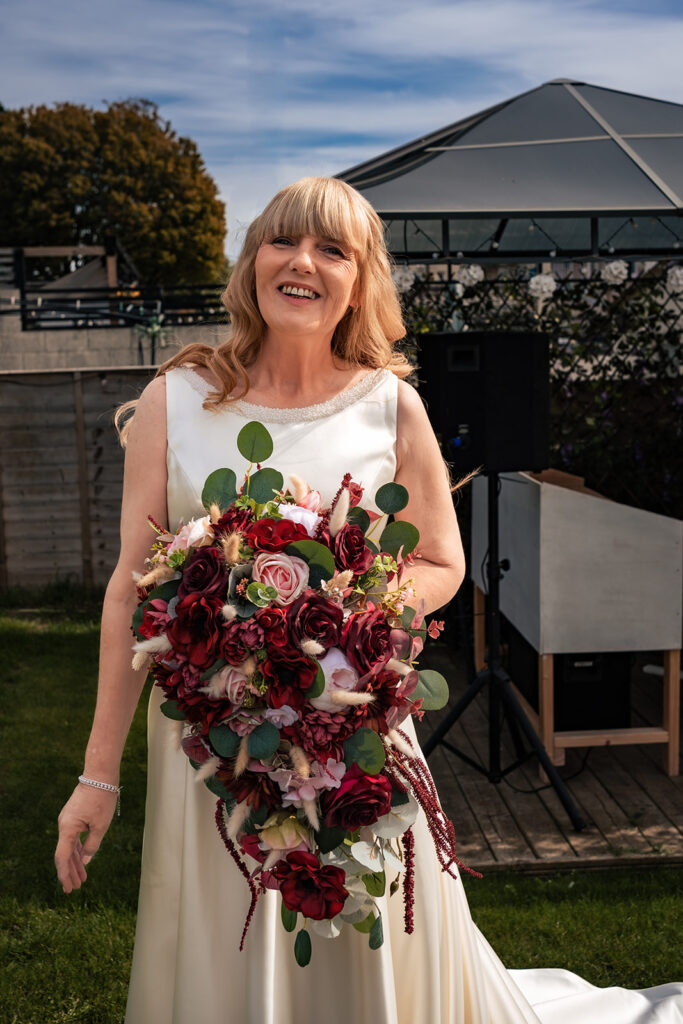 Bride with her red and white bouquet on the morning of a Portsmouth wedding
