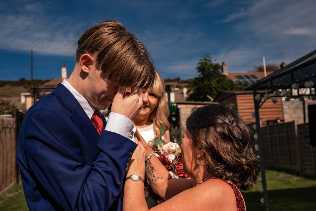 Bride's son wiping away happy tears on the morning of a Portsmouth wedding