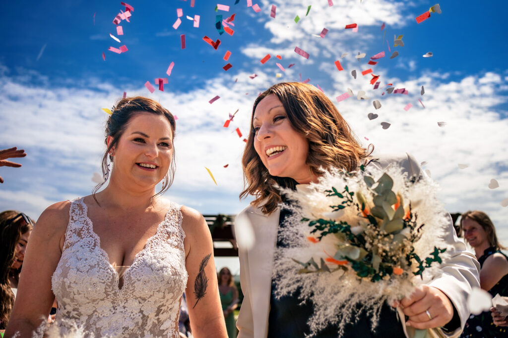 Confetti for two brides at Southlands Barn, West Sussex