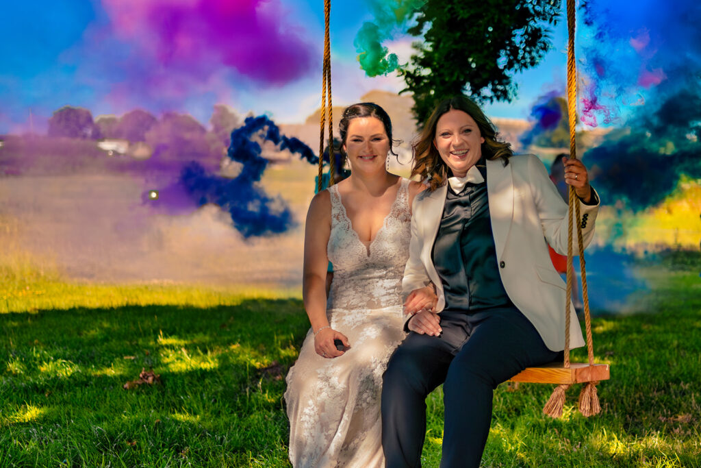Two brides with colourful smoke bombs at Southlands Barn, West Sussex