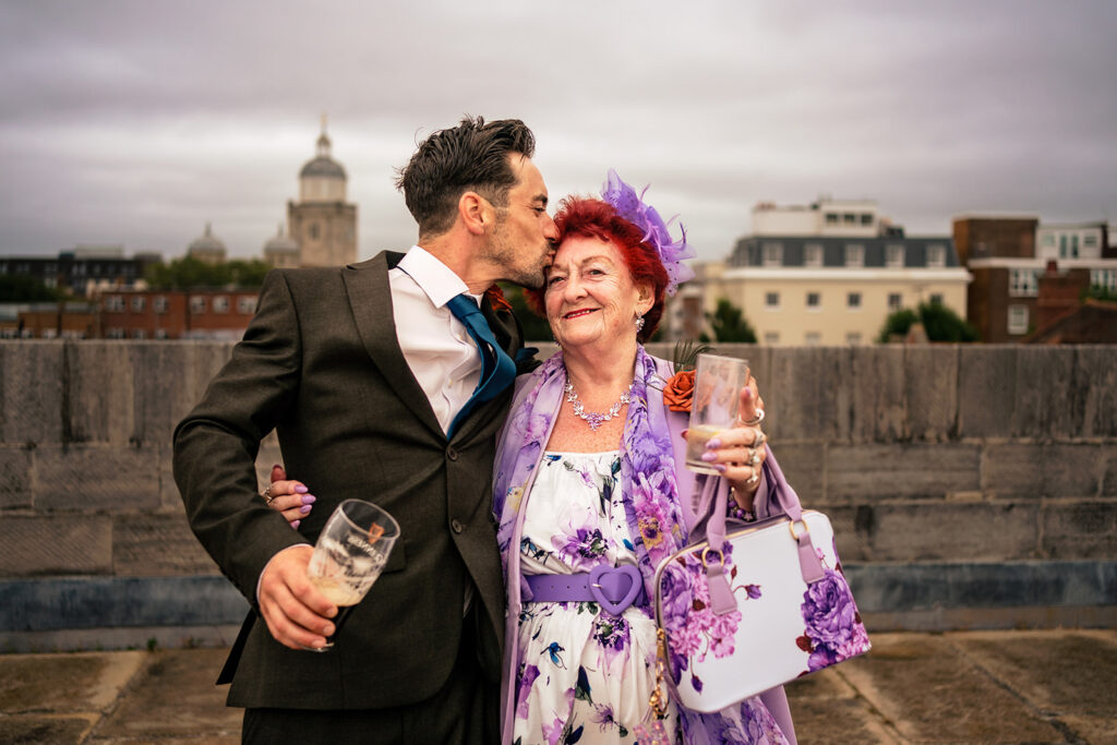 Bride and groom with a guest on the walls at The Square Tower, Old Portsmouth