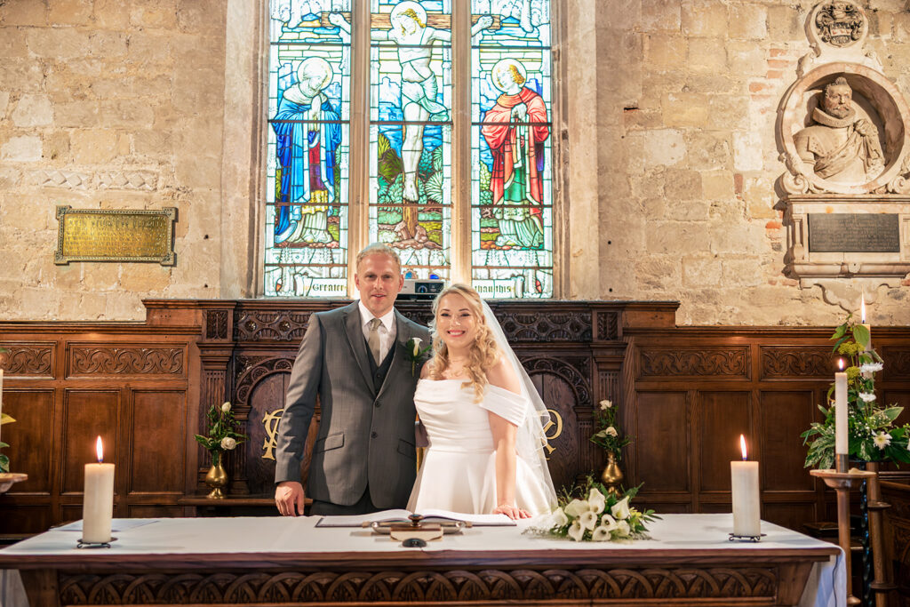 Bride and groom at the altar at St Mary's Church, Portchester
