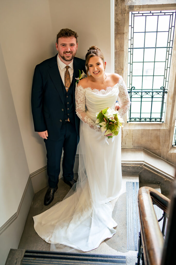 Bride and groom by the window at Winchester Register Office, Hampshire