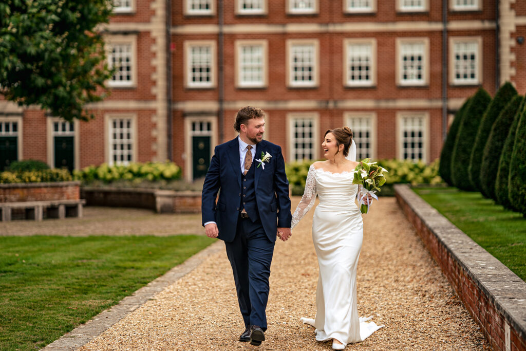 Bride and groom walking in the gardens at the Winchester Military Museums gardens, Hampshire