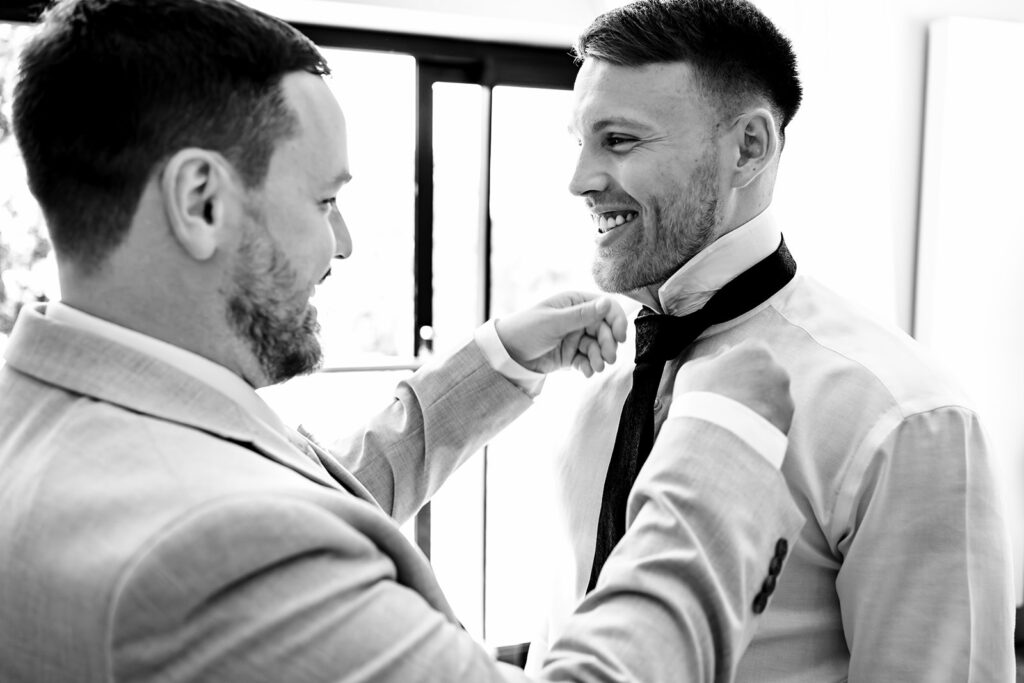 Groom fixing his tie before the ceremony at Old Thorns Hotel and Resort, Liphook