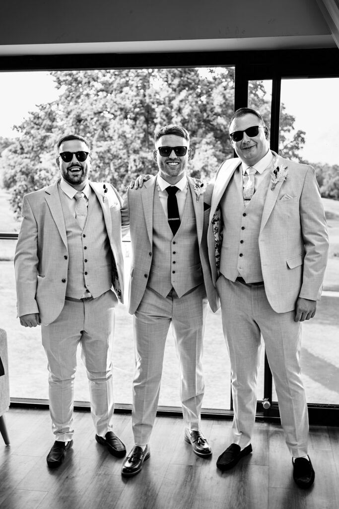 Groomsmen lined up, black and white at Old Thorns Hotel and Resort, Liphook