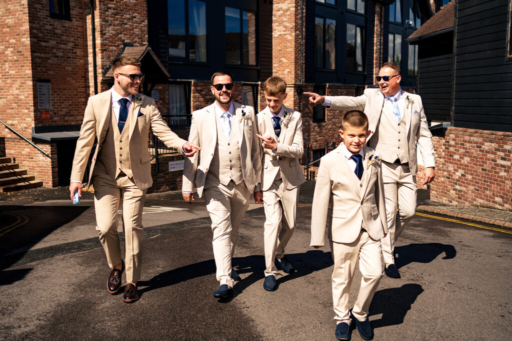Groomsmen walking in together at Old Thorns Hotel and Resort, Liphook