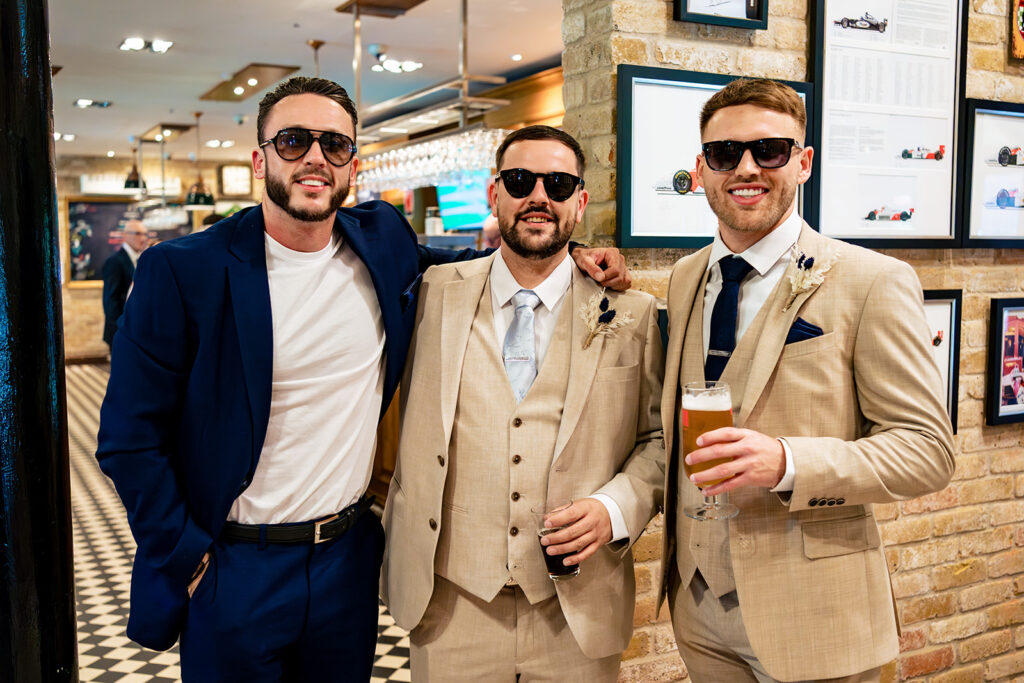 Groomsmen in sunglasses larking about at Old Thorns Hotel and Resort, Liphook