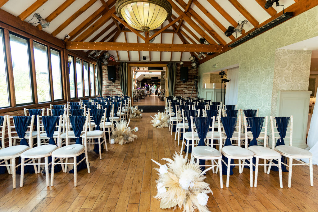 The aisle lined with pampas grass florals at Old Thorns Hotel and Resort, Liphook