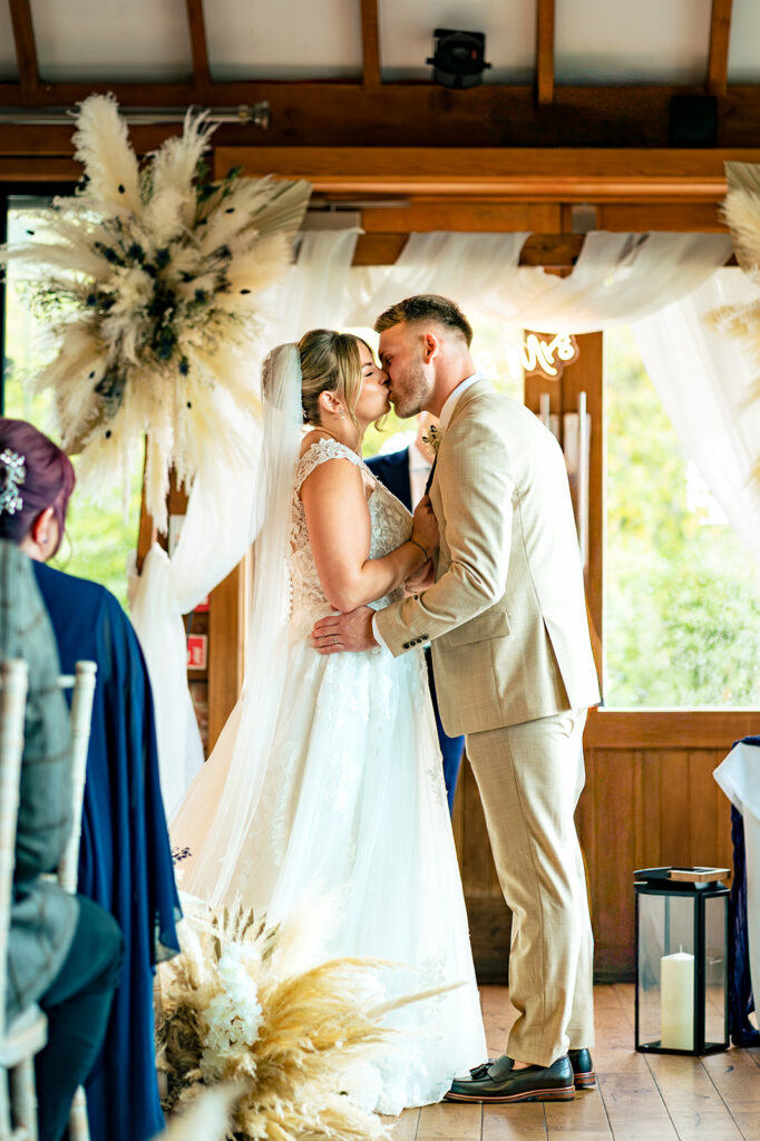 Just married kiss at Old Thorns Hotel and Resort, Liphook