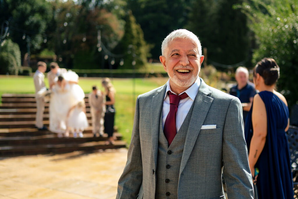 Guest laughing in the sunshine at Old Thorns Hotel and Resort, Liphook