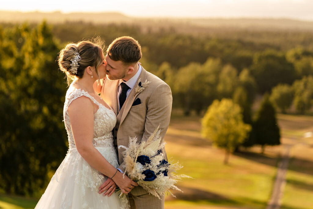 Couple with sweeping golf course views at Old Thorns Hotel and Resort, Liphook