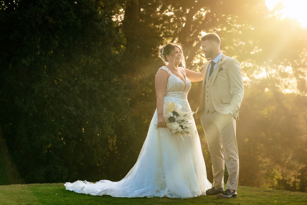 Bride on the lawn in the evening light at Old Thorns Hotel and Resort, Liphook