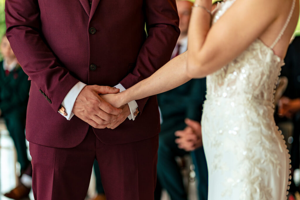 Holding hands during the ceremony at The Post Barn, Newbury