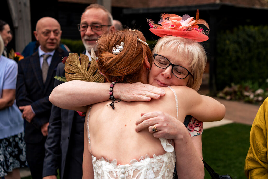 Bride hugging a guest at The Post Barn, Newbury