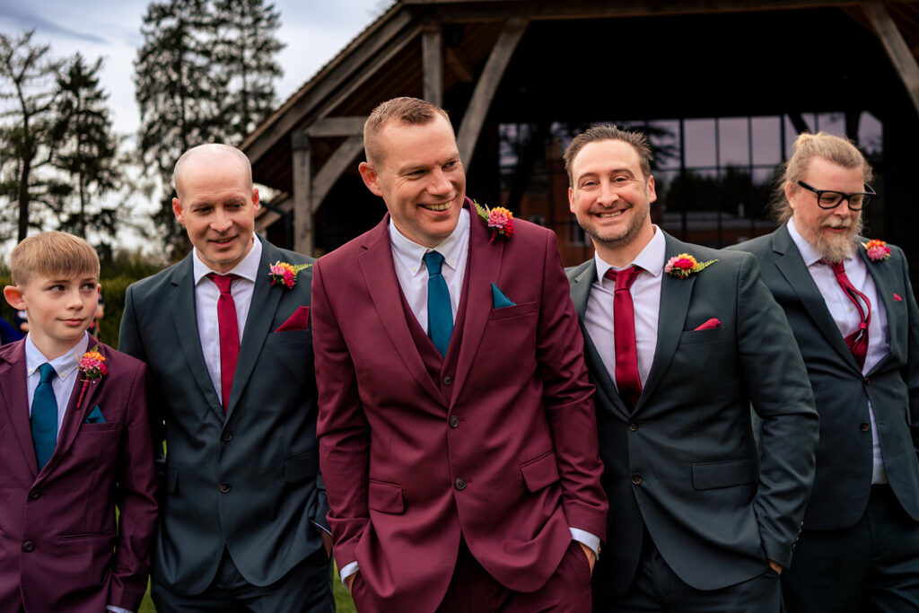 Groom laughing with his groomsmen at The Post Barn, Newbury