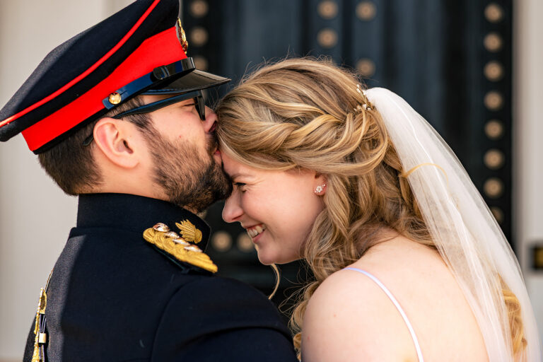 Bride and groom in dress uniform, close up at Royal Military Academy Sandhurst