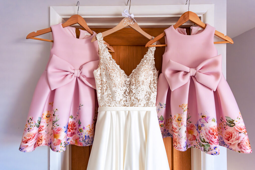Pink flower girl dresses hanging up at Great Ballard School, Eartham