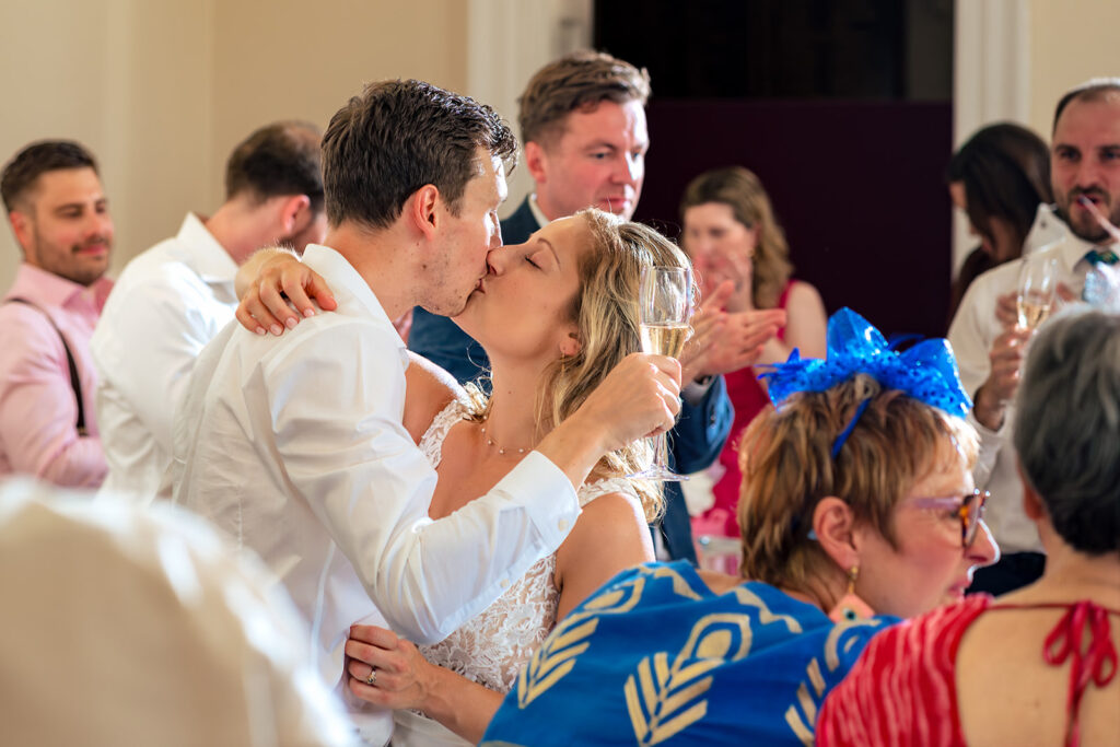 Bride laughing at dinner at Great Ballard School, Eartham