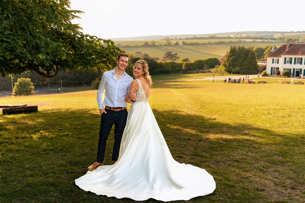 Couple at sunset with the house behind at Great Ballard School, Eartham