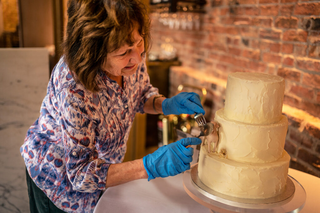 Wedding cake being finished at Dorfold Hall, Cheshire