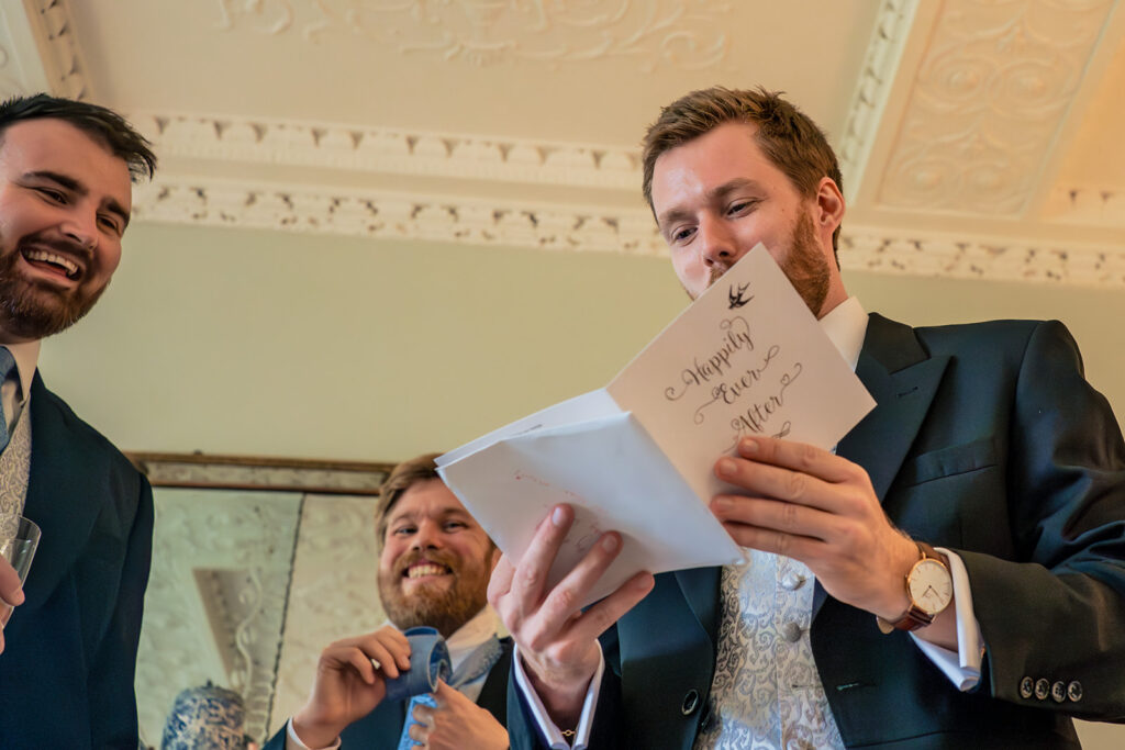 Groomsman reading his speech notes at Dorfold Hall, Cheshire