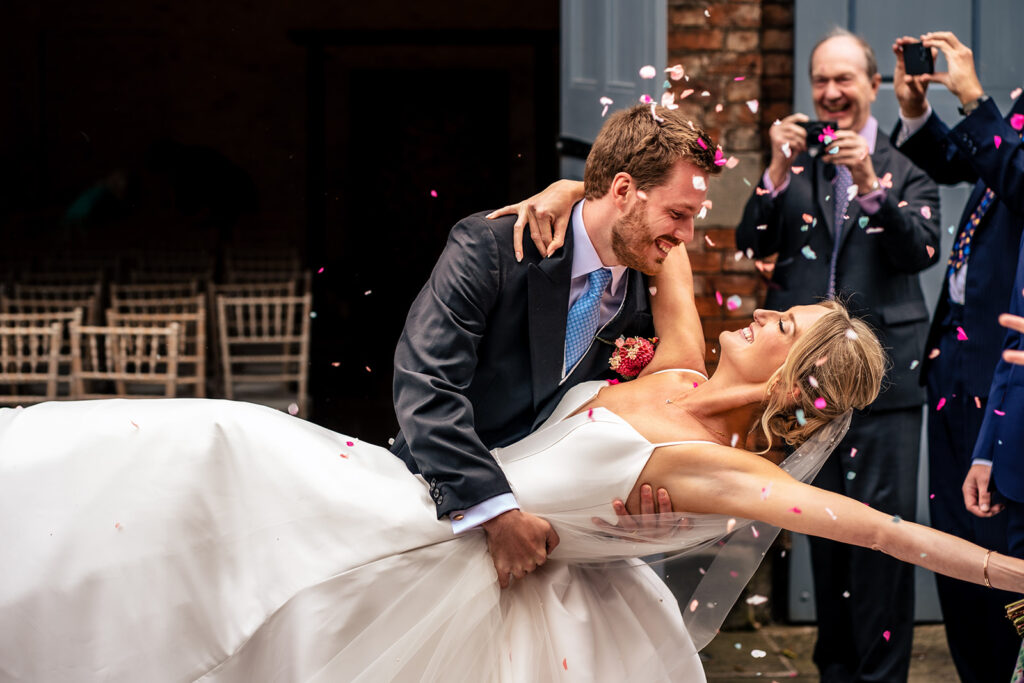 Groom dipping the bride for a kiss at Dorfold Hall, Cheshire