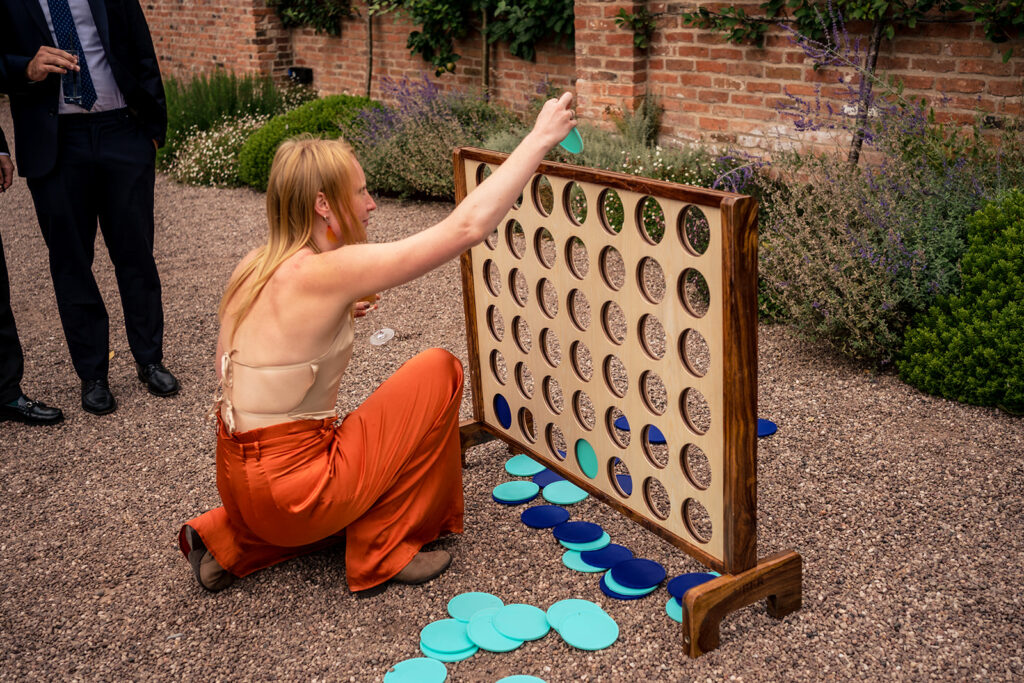 Guest playing giant Connect Four at Dorfold Hall, Cheshire