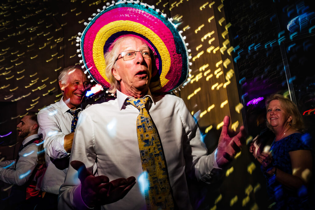 Guest in a sombrero on the dancefloor at Dorfold Hall, Cheshire