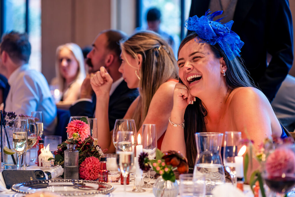 Guests laughing at dinner at Dorfold Hall, Cheshire