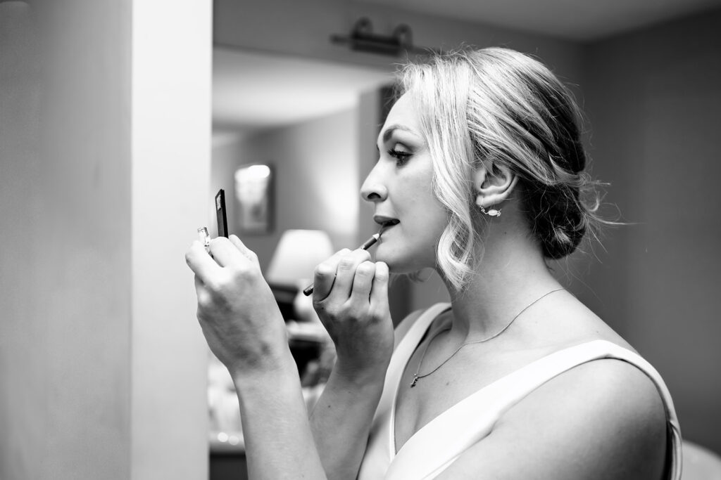 Bride getting ready, black and white at Houghton Lodge Gardens, Hampshire