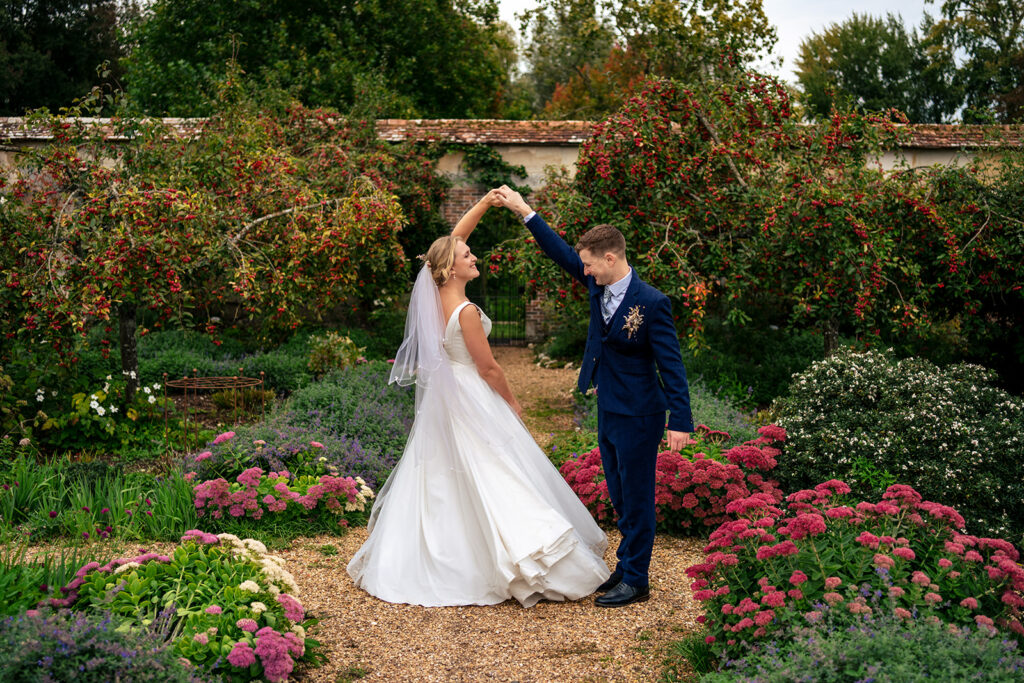 Newlyweds in the flower garden at Houghton Lodge Gardens, Hampshire