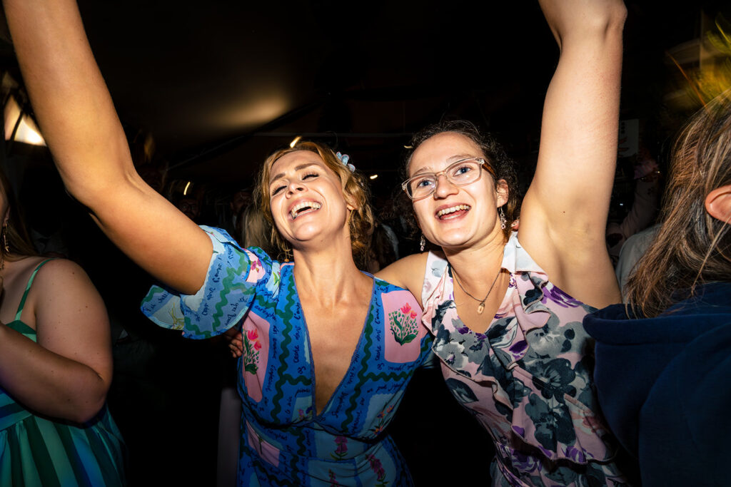 Guests jumping on the dancefloor at Houghton Lodge Gardens, Hampshire