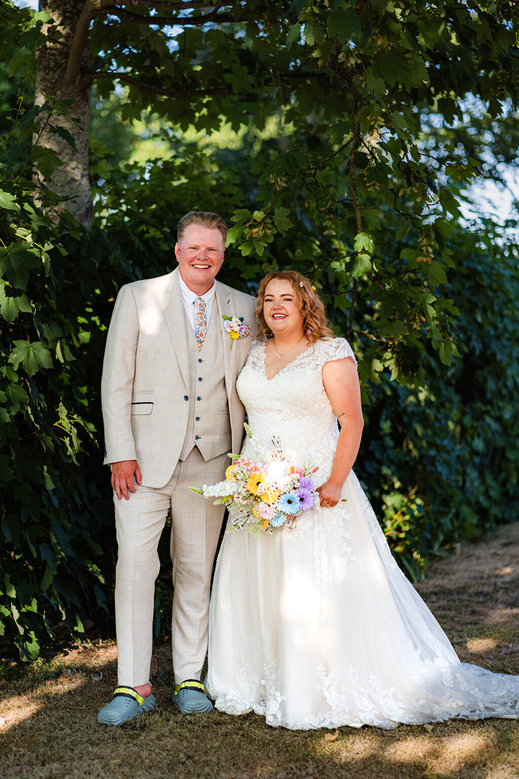 Bride and groom portrait in the corner of a car park in natural light, before flash