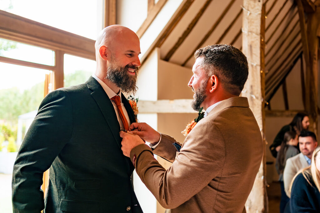 Groomsmen fixing buttonholes at Skylark Golf and Country Club, Whiteley