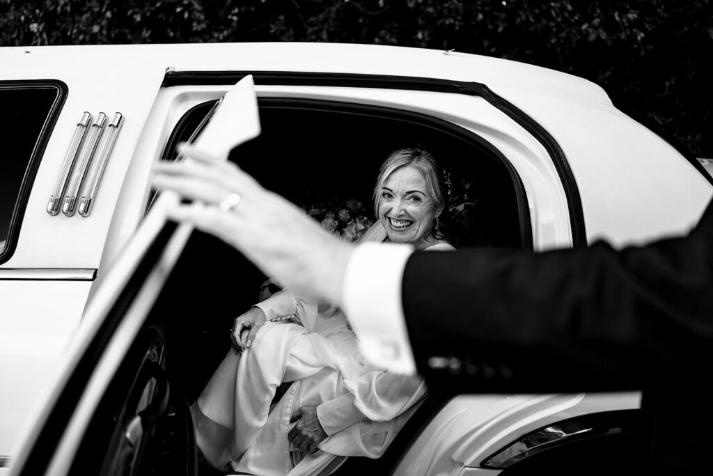 Bride arriving in the wedding car, black and white