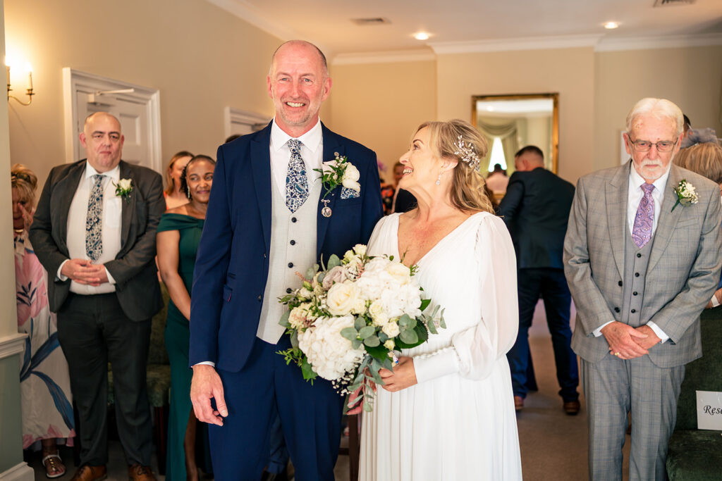 Bride and groom at the front of the ceremony room