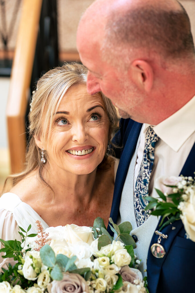 Groom kissing the bride’s cheek