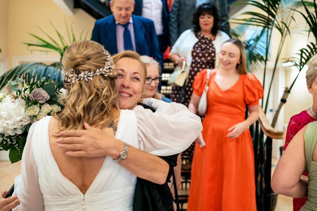 Bride hugging guests after the ceremony