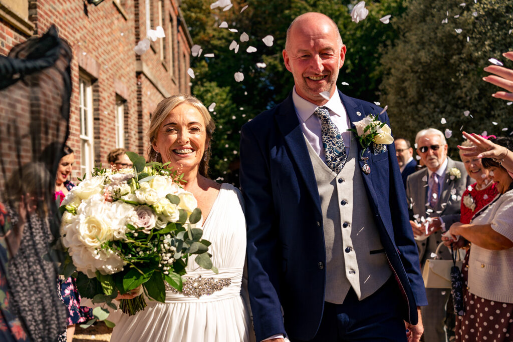 Newlyweds with guests outside the register office