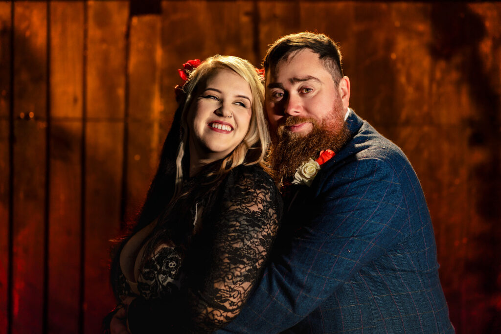Couple cuddled up in the pub at Halloween micro wedding, Southampton