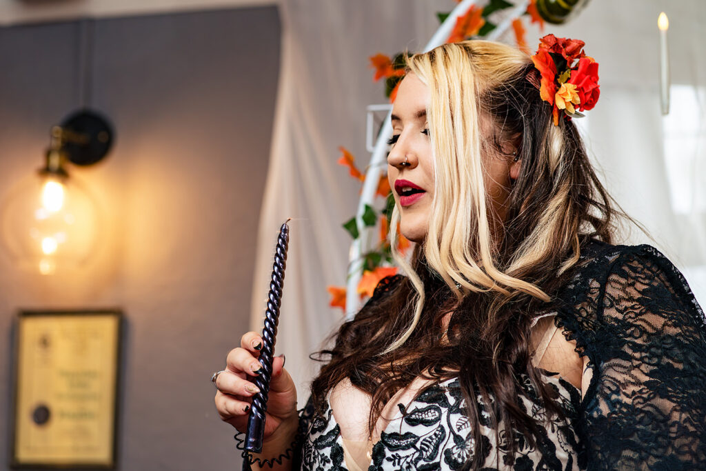 Bride with red flowers in her hair at Halloween micro wedding, Southampton