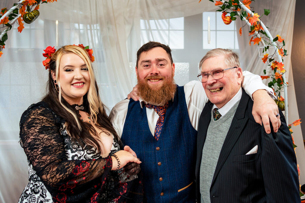 Newlyweds laughing with a guest at Halloween micro wedding, Southampton